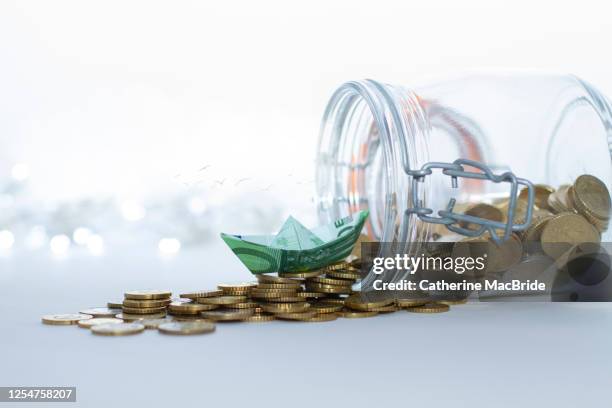 sailing out on savings sea - jar stock pictures, royalty-free photos & images