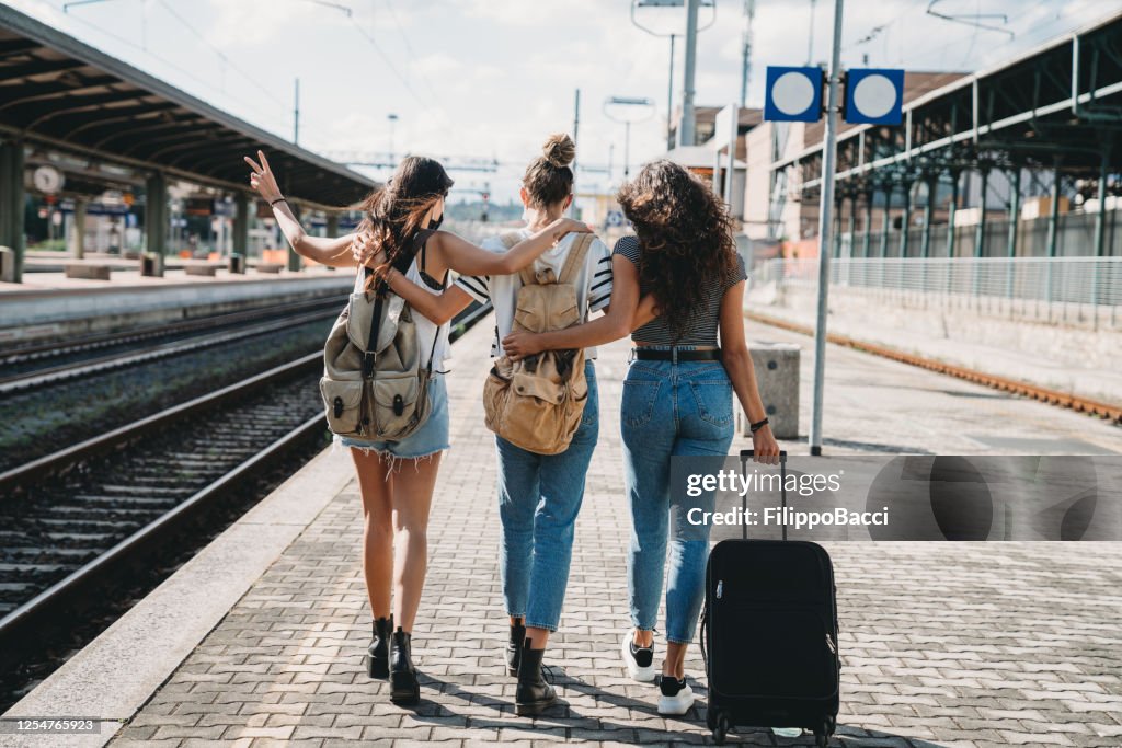 Three friends enjoying a trip together - Rear view