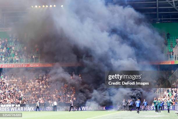 Smokebombs on the field during the Dutch Eredivisie match between FC Groningen and AFC Ajax at Euroborg on May 14, 2023 in Groningen, Netherlands.