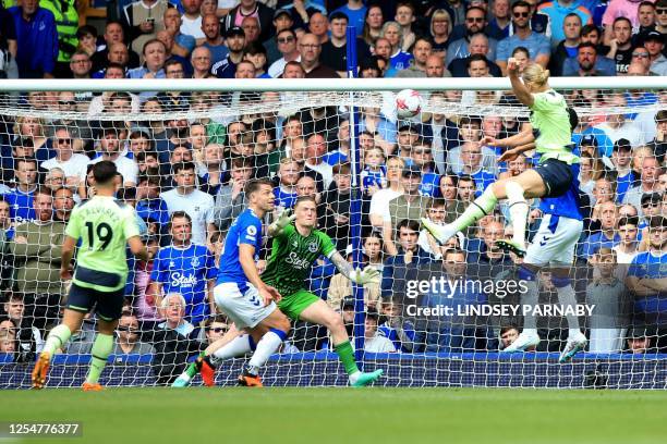 Manchester City's Norwegian striker Erling Haaland heads the ball and scores his team's second goal during the English Premier League football match...