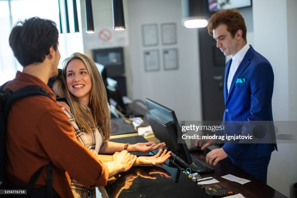 Young couple checking in at luxury hotel