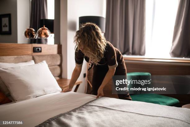 chambermaid making bed at hotel suite - neatly made bed stock pictures, royalty-free photos & images