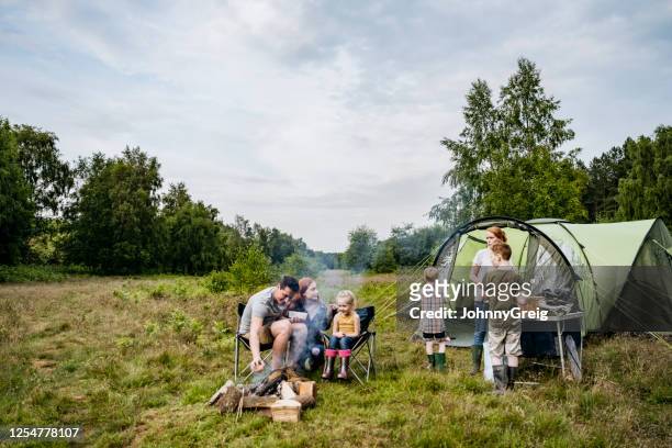 father and mother with children on springtime camping trip - camping equipment stock pictures, royalty-free photos & images