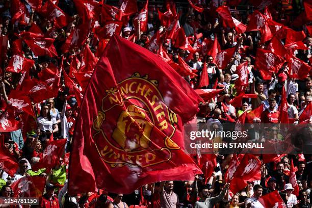 Manchester United's supporters wave flags of their team as they cheer during the English Women's FA Cup final football match between Chelsea and...