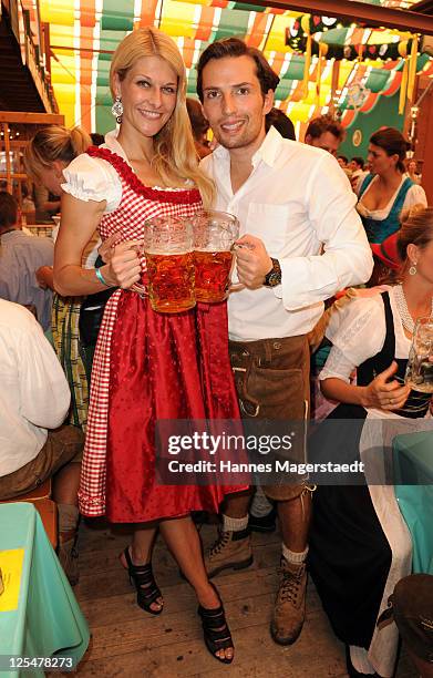 Qurin Berg and girlfriend Natascha Gruen attend the Oktoberfest beer festival at Schuetzenzelt beer tent on September 17, 2011 in Munich, Germany.