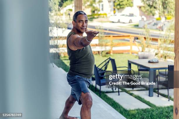 mature man practicing yoga outdoors - adult male vest exercise stock pictures, royalty-free photos & images