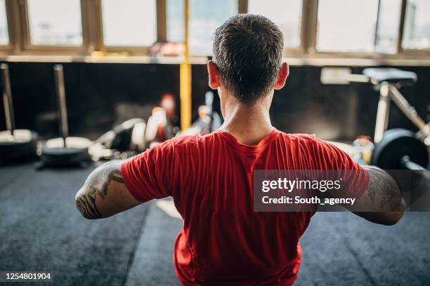Strong Man Doing Exercise On Rope Pull Machine In The Gym High-Res
