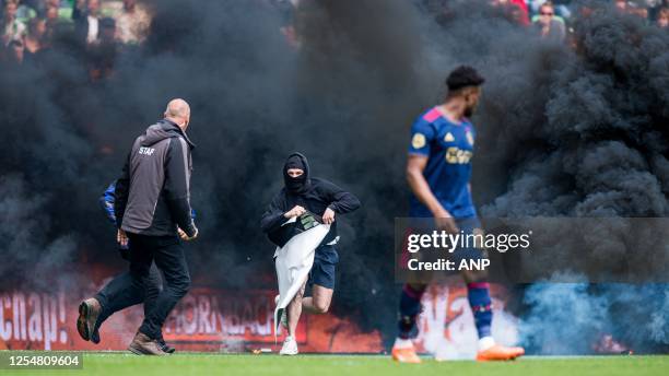 Groningen supporter storms the pitch with a banner Mohammed Kudus of Ajax during the Dutch premier league match between FC Groningen and Ajax at the...