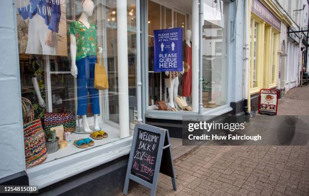 General view of the signage welcoming shoppers back at Cwcw ladies clothing premises on July 7, 2020 in Crickhowell, Wales, United Kingdom. Social...