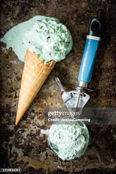 mint choc chip ice cream cone on rusty background - mint ice cream stock pictures, royalty-free photos & images