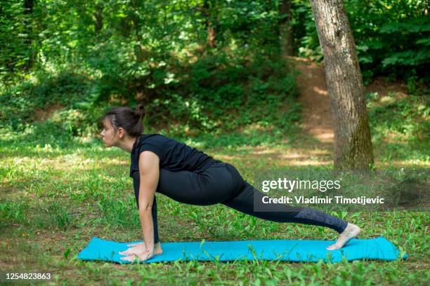 yoga practice in the nature - sun salutation stock pictures, royalty-free photos & images