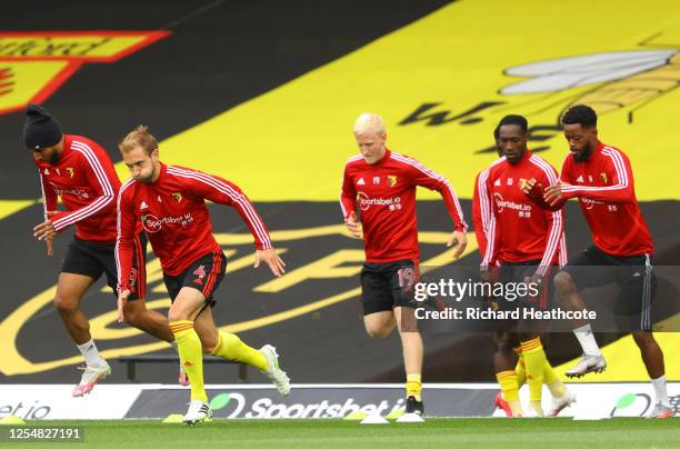 Troy Deeney, Craig Dawson, Will Hughes and Danny Welbeck of Watford warm up prior to the Premier League match between Watford FC and Norwich City at...