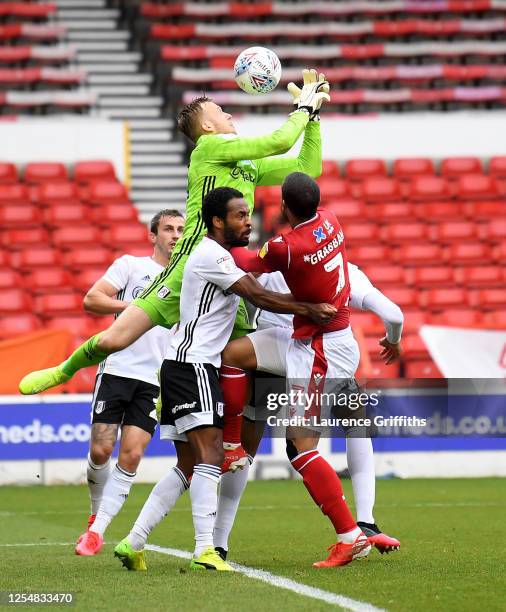 Marek Rodák of Fulham is challenged for the ball during the Sky Bet Championship match between Nottingham Forest and Fulham at City Ground on July...