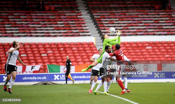 Marek Rodák of Fulham is challenged for the ball during the Sky Bet Championship match between Nottingham Forest and Fulham at City Ground on July...