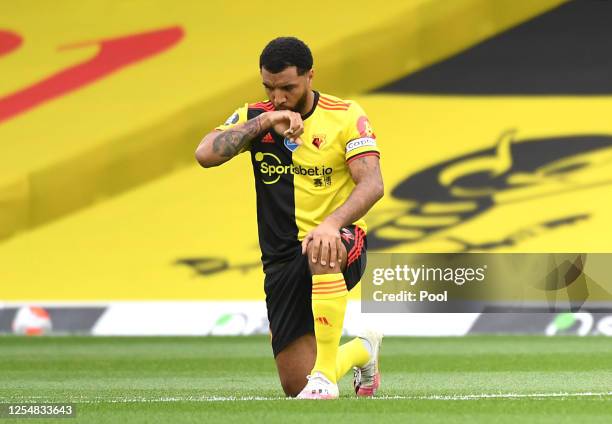 Troy Deeney of Watford takes a knee in support of the Black Lives Matter movement during the Premier League match between Watford FC and Norwich City...