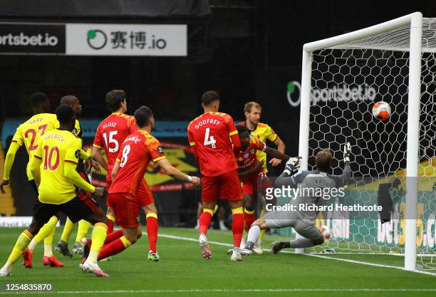 Craig Dawson of Watford scores his team's first goal during the Premier League match between Watford FC and Norwich City at Vicarage Road on July 07,...
