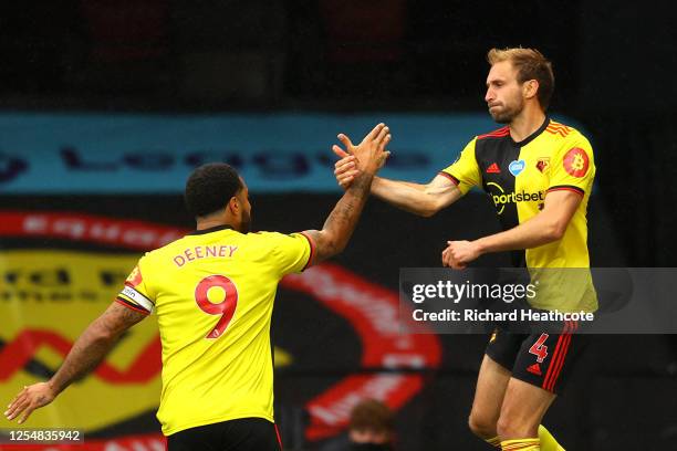 Craig Dawson of Watford celebrates with teammate Troy Deeney after scoring his team's first goal during the Premier League match between Watford FC...
