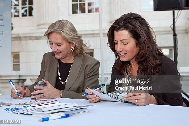 Vicki O'Meara, Executive Vice President and President, Pitney Bowes Management Services, and singer/songwriter Amy Grant sign holiday cards at the...