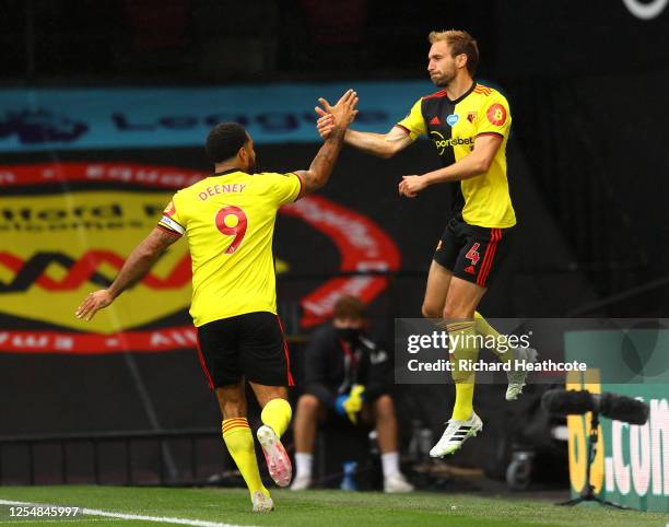 Craig Dawson of Watford celebrates with teammate Troy Deeney after scoring his team's first goal during the Premier League match between Watford FC...