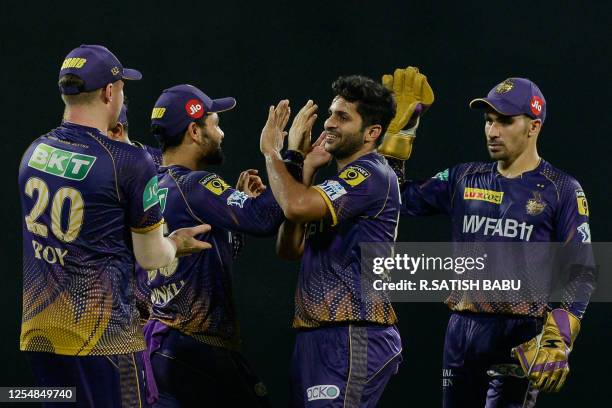 Kolkata Knight Riders' Shardul Thakur celebrates with teammates after taking the wicket of Chennai Super Kings' Devon Conway during the Indian...