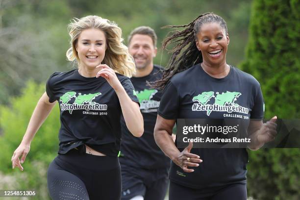 Actress Nina Ensmann, moderator Florian Ambrosius and actress Liz Baffoe run during the photo call for "ZeroHungerRun Challenge" on July 07, 2020 in...