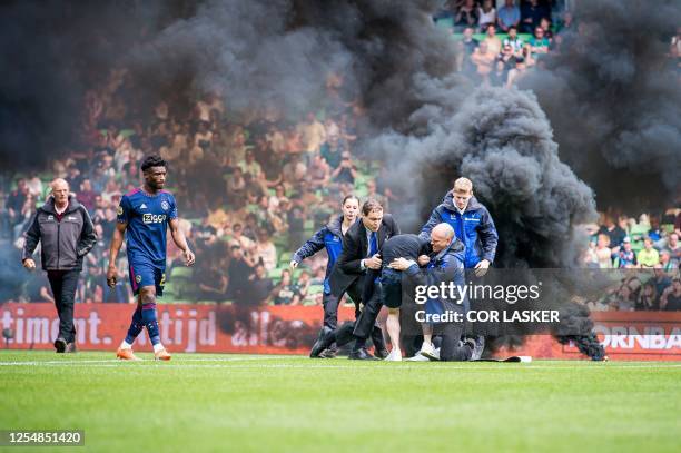Supporter storms the field during the Dutch Premier league football match between FC Groningen and Ajax Amsterdam at the Euroborg stadium in...