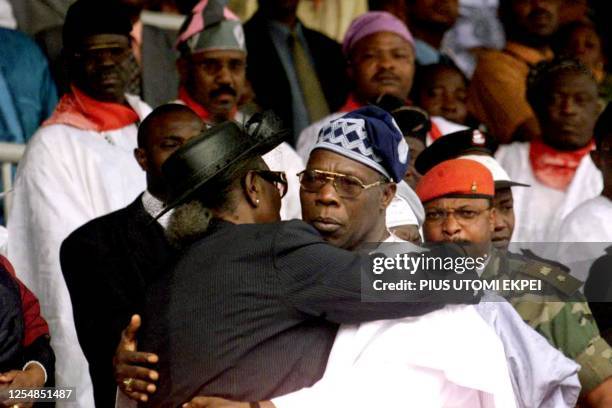 Nigerian President Olusegun Obasanjo embraces Atinuke Ige, wife of the slain Attorney-General and Justice Minister Bola Ige 11 January 2002 during...