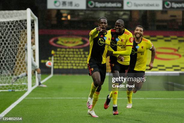 Danny Welbeck of Watford celebrates with teammates Abdoulaye Doucoure and Troy Deeney after scoring his team's second goal during the Premier League...
