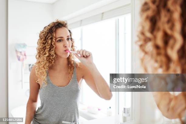 make sure your smile is looking it's best - brushing teeth mirror stock pictures, royalty-free photos & images