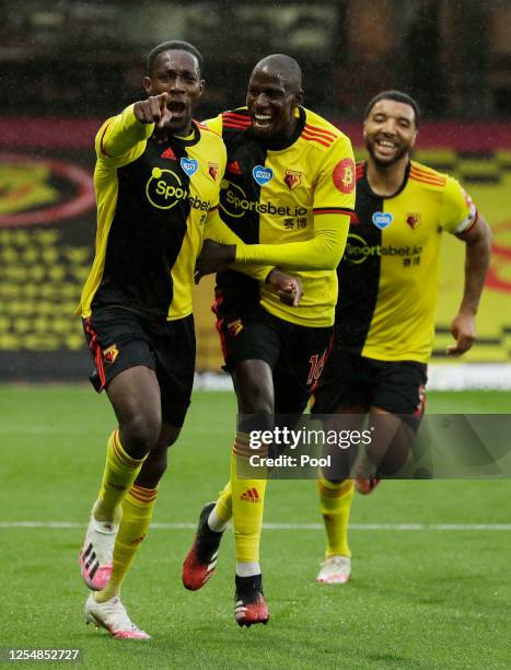 Danny Welbeck of Watford celebrates with teammate Abdoulaye Doucoure after scoring his team's second goal during the Premier League match between...