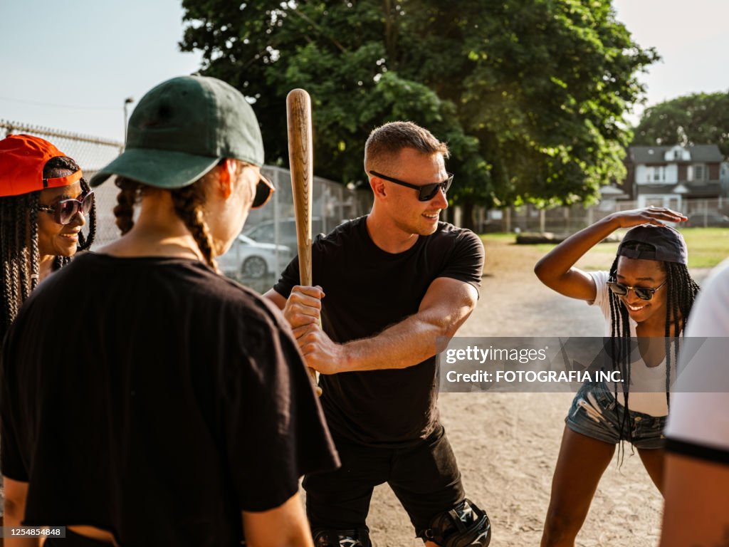 Diverse group of young people playing softball