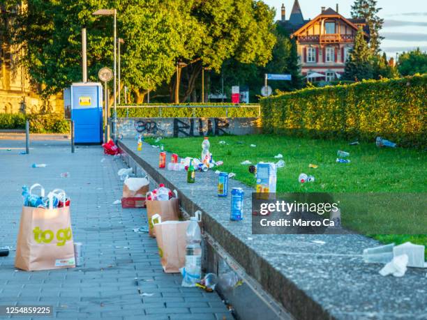 littering, garbage left in the parkterrasse from saturday evening to sunday morning - littering stock pictures, royalty-free photos & images