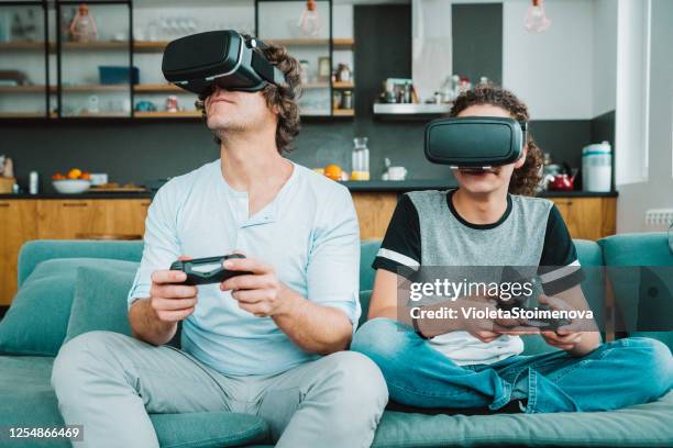 father and son playing with vr - watching parents fight stock pictures, royalty-free photos & images