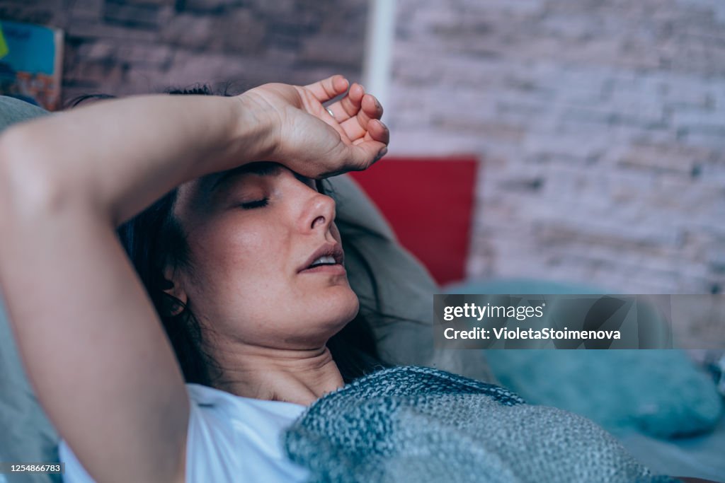 Woman with high fever at home.