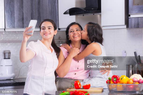 chopping vegetables in kitchen stock photo - mother and girl stock pictures, royalty-free photos & images