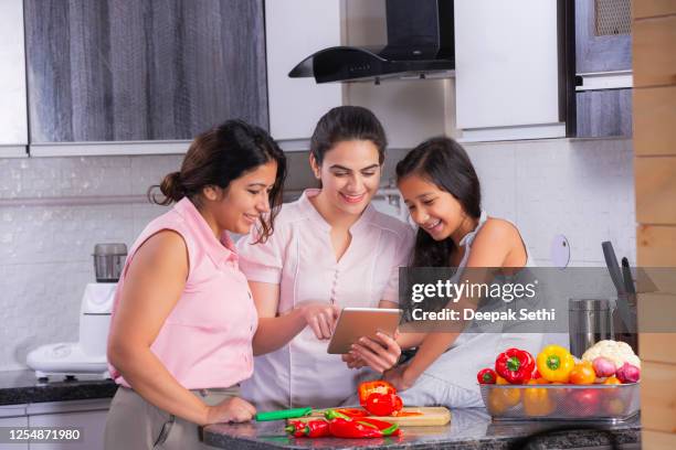 chopping vegetables in kitchen stock photo - indian society and daily life stock pictures, royalty-free photos & images