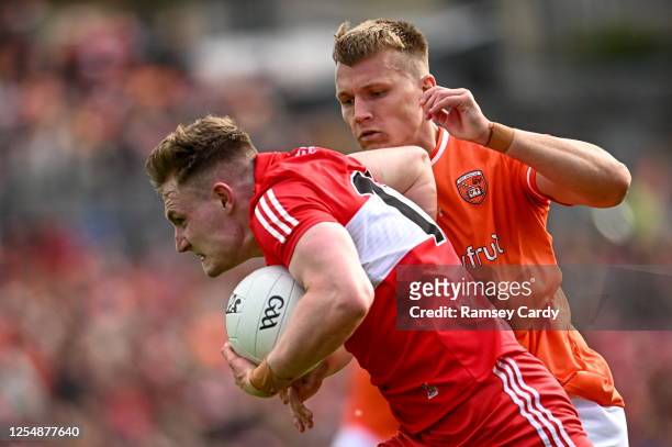 Monaghan , Ireland - 14 May 2023; Ethan Doherty of Derry in action against Rian O'Neill of Armagh during the Ulster GAA Football Senior Championship...