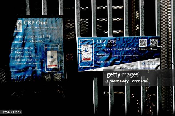 Signs annoucing the CPB One mobile application at the port of entry along the U.S.-Mexico border on Saturday, May 13, 2023 in Mexicali, Baja...
