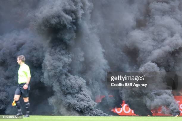 Smoke bombs on the pitch thrown by FC Groningen fans during the Dutch Eredivisie match between FC Groningen and Ajax at Euroborg on May 14, 2023 in...