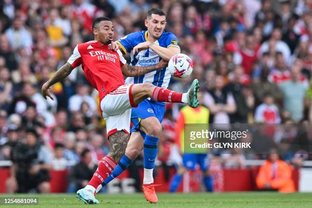 Arsenal's Brazilian striker Gabriel Jesus fights for the ball with Brighton's English defender Lewis Dunk during the English Premier League football...