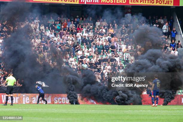 Smoke bombs on the pitch thrown by FC Groningen fans during the Dutch Eredivisie match between FC Groningen and Ajax at Euroborg on May 14, 2023 in...