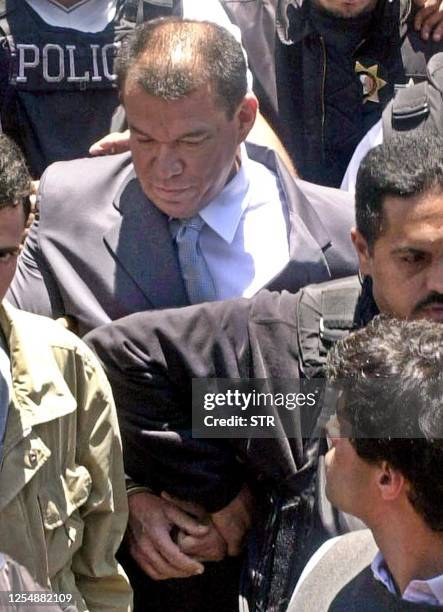 Former Venezuelan Interior Minister Ramon Rodriguez Chacin is escorted by police, 12 April 2002, after being captured at his residence in Caracas....