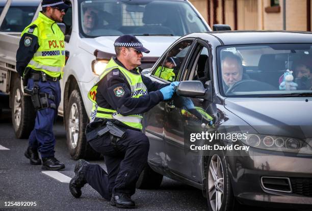 Police stop and question drivers at a checkpoint on July 8, 2020 in Albury, Australia. The NSW-Victoria border closed at midnight, Wednesday 8 July....