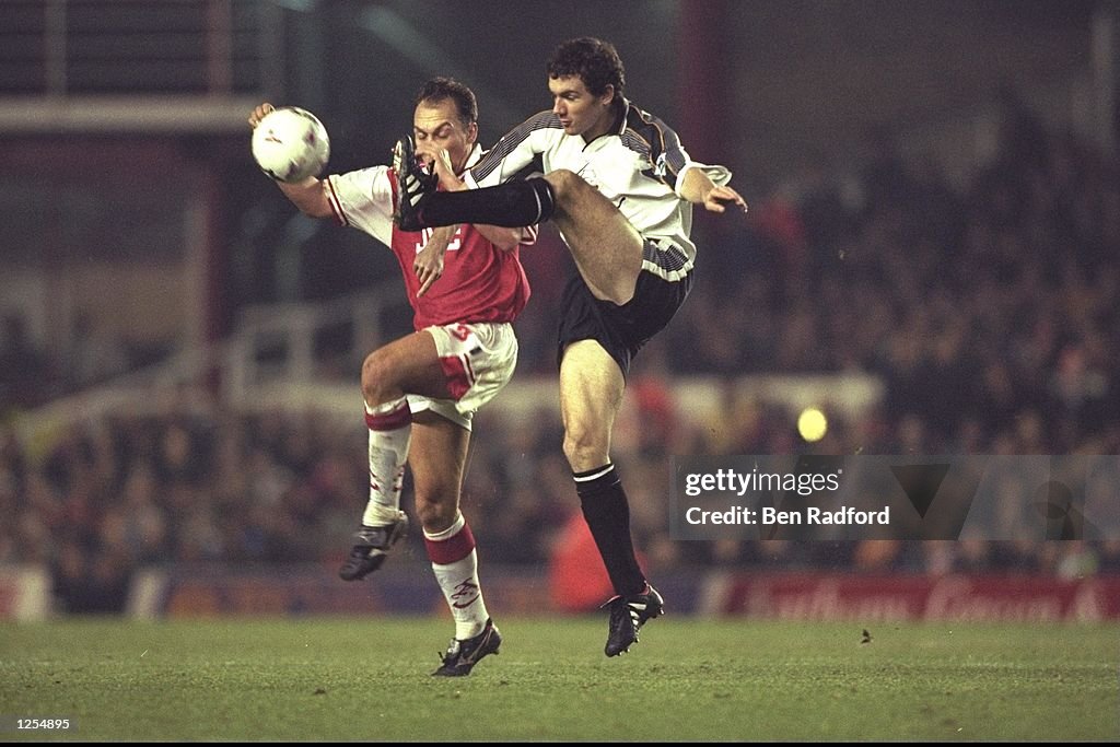 Christian Dailly of Derby (right) gets his foot to the ball before David Platt