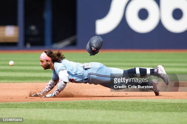 The throw beats Bo Bichette of the Toronto Blue Jays to second base as he tries to stretch an extra base hit in the fourth inning of the MLB game...