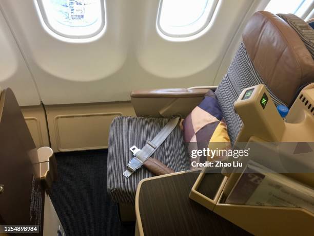 the business class cabin of etihad airways a330 aircraft - etihad stock pictures, royalty-free photos & images