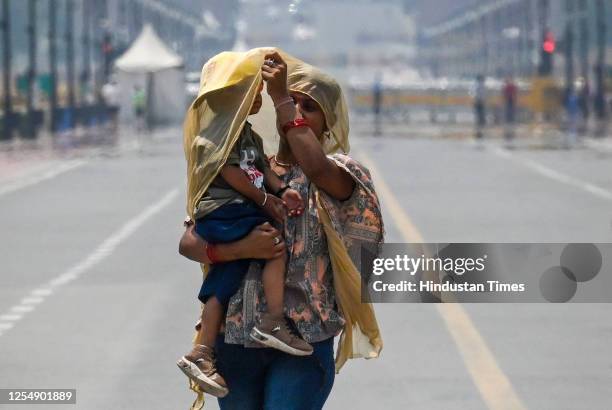 Commuters out on a hot summer day at Kartavya Path, on May 14, 2023 in New Delhi, India.