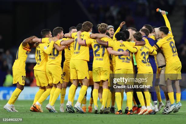 Barcelona's players celebrate winning their 27th Spanish league championship after the Spanish league football match between RCD Espanyol and FC...