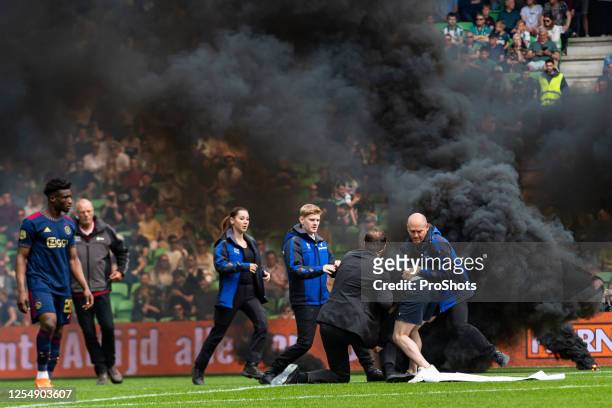 Dutch Eredivisie Football.Ajax player Mohammed Kudus Pitch invader caught by security during the match Groningen - Ajax - Photo by Icon sport during...
