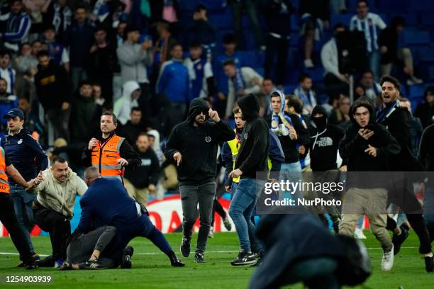 Espanyol fans invade pitch and throw objects at Barcelona players and police after the LaLiga Santander match between RCD Espanyol and FC Barcelona...